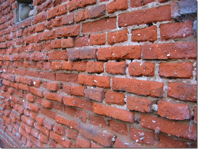 Old, eroded brick wall